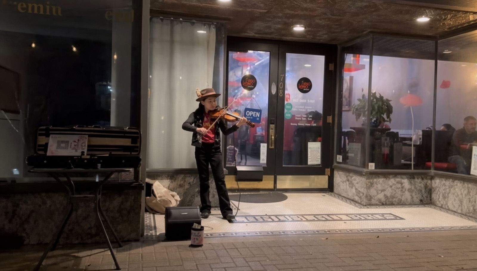Evening violin performance outside a restaurant