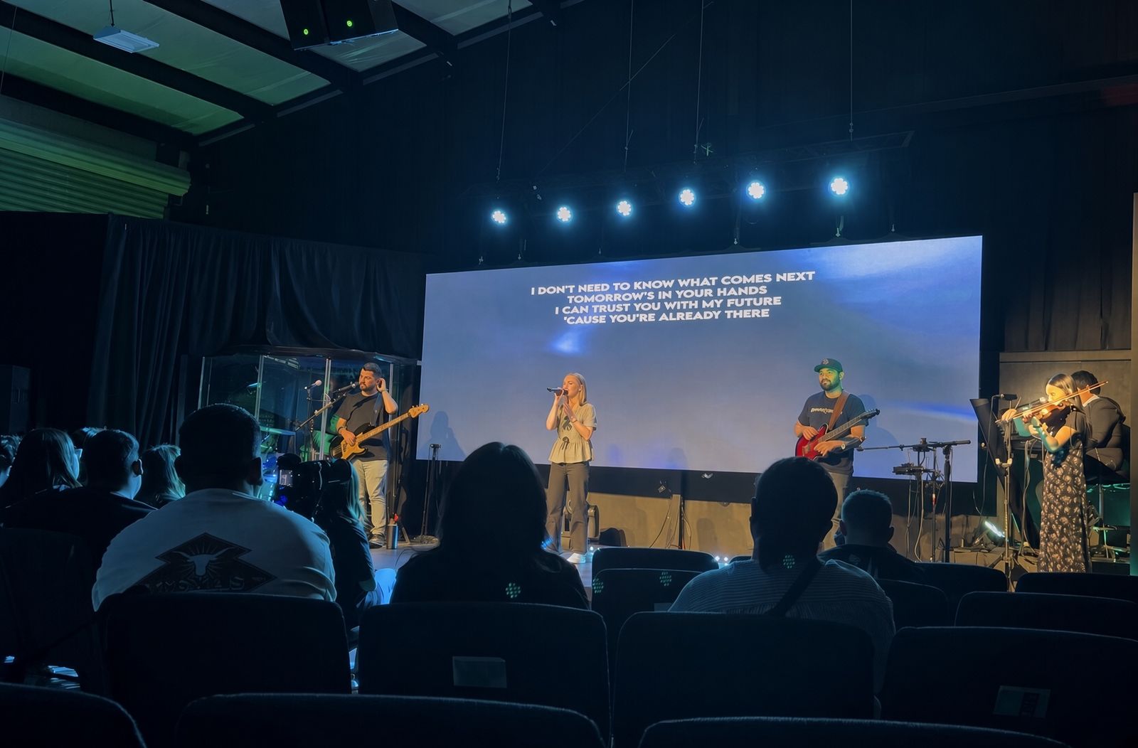 Playing violin with a worship band on stage